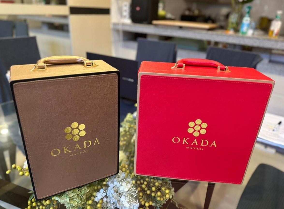 Premium resort-branded rigid gift boxes in brown and red